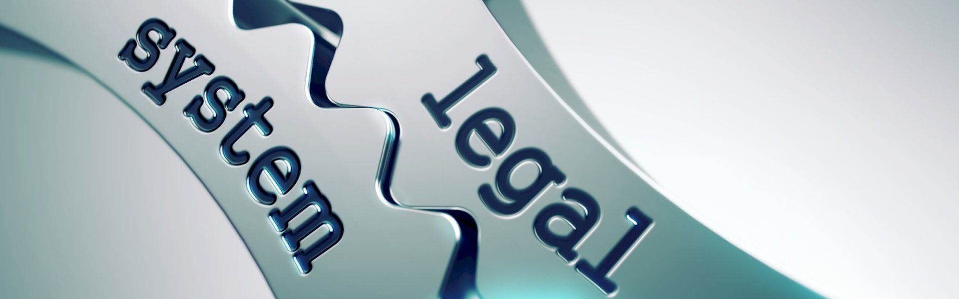 Metal cogs engraved ‘legal system’, symbolising structured legal support for family law and personal injury